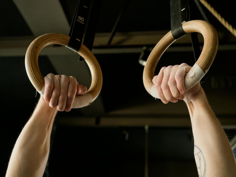 Close up of a person hands holding gym rings.